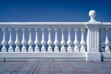 Fototapeta premium White stone balustrade with clear blue sky and paved walkway