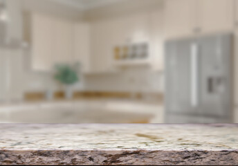 Empty marble top table with blurred kitchen interior Background. for product display.