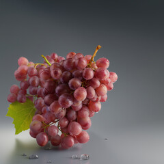 Fototapeta premium Perfect bunch of pink grapes with water drops on a clean background