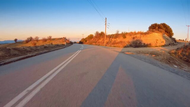 Remote scenery, countryside road POV drive trip, brown reddish nature, sunny