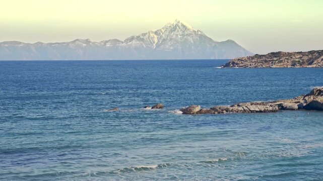 Beautiful coastal scenery mountain peak skyline azure blue sea rolling waves