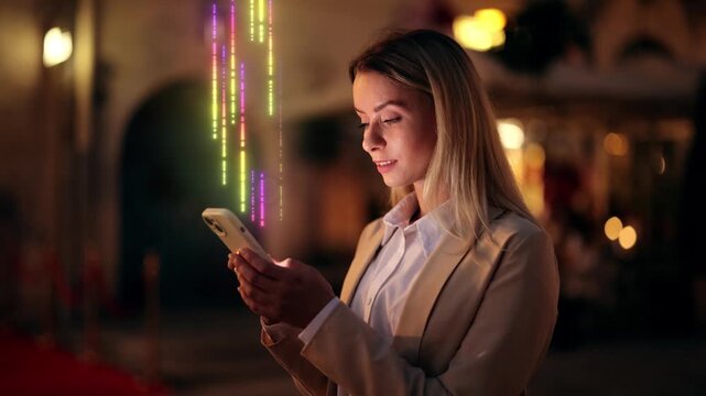 Young woman in business attire using smartphone at night with colorful holographic data streams, futuristic digital overlay. Visualization of Information Lines Flying from Mobile Phone