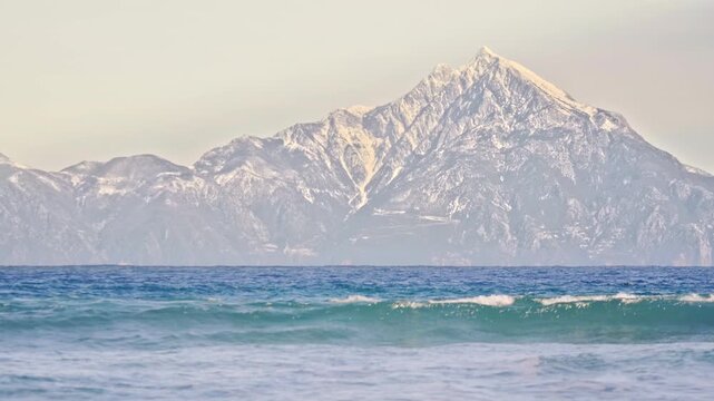 Beautiful seascape, Mount Athos dramatic high peak, waves, blue water, Greece