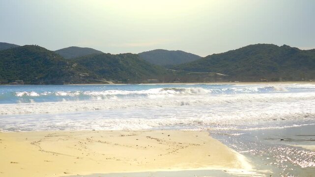 Greece coastline, rolling waves sandy beach, drainage basin clear water, sunny