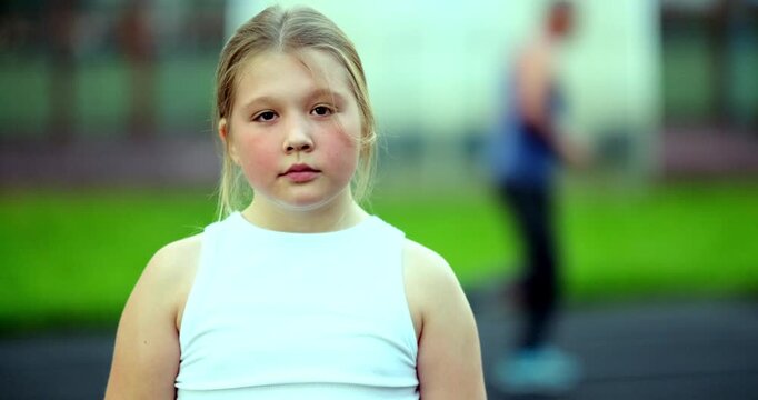 Blonde teen in outdoor stadium