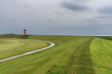 Obraz premium view of the iconic Pilsum Lighthouse on the Wadden Sea coast of northern Germany