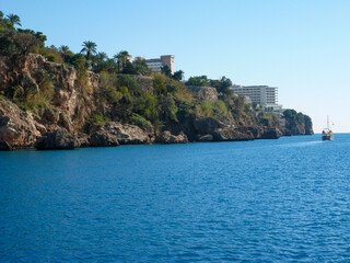Naklejka premium A panoramic view of the cliff in Antalya, Turkey as seen from a tour boat on the Mediterranean sea.