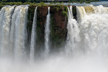 A massive, wide waterfall with powerful cascades and a cloud of mist, showcasing the raw, untamed force of nature for themes of power, natural wonder, and epic landscapes