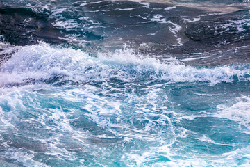 Fototapeta premium The ocean is calm and blue, with a few small waves