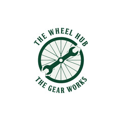Logo design featuring a bicycle wheel and wrench, symbolizing repair and maintenance services