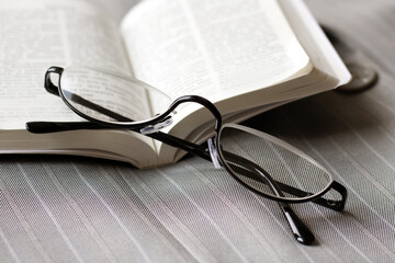 Men's lecturer glasses for reading on a book.