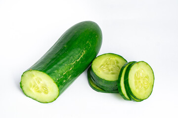 Fresh cucumber with sliced pieces on white background 