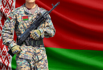 Fototapeta premium Belarus flag with soldier holding assault rifle