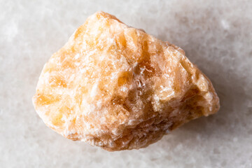 sample of uncut brown calcite rock on white