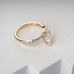 Pear Diamond Gold engagement ring with side diamond for women and girls creative image for ecommerce 