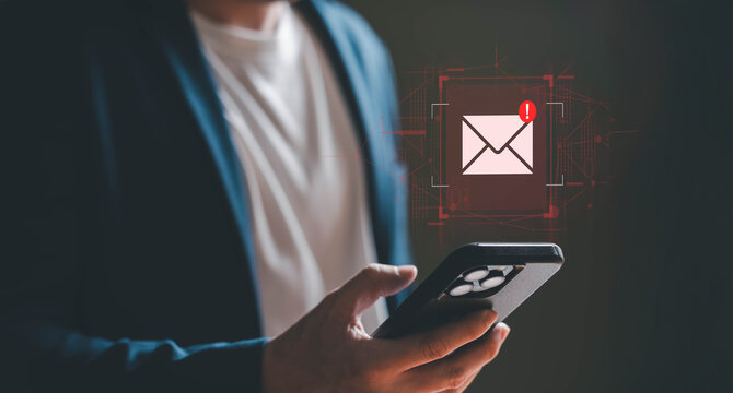 Business man using smartphone and computer that show warning sign after got attack phishing email by malware from hacker that commit cyber crime or software crash to cause an error.