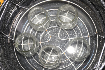 glass jars in water bath for Homemade Black Berry Jelly Canning with boiling Water bath for food preservation in glass jars