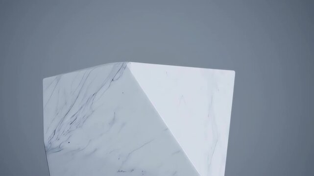 Geometric white marble-like object against a muted gray background