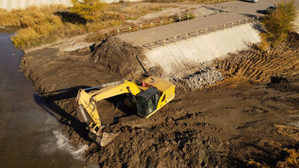 Excavator at a Riverbed Construction Site