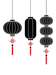 Three traditional black chinese lanterns with red tassels hanging