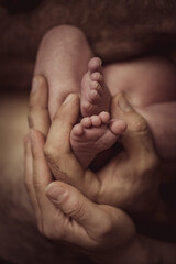Fototapeta premium Sleeping baby boy sleeping on mother hands closeup top view. Motherhood, breastfeeding