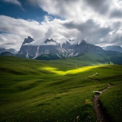 Majestic Mountain Peaks Touch Dramatic Clouds Over Lush Green Rolling Hills