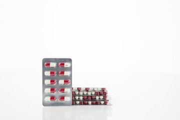 Red and white antibiotic capsule pill in blister pack. Prescription drug clindamycin 300 mg for bacterial infection treatment healthcare and pharmaceutical use. Healthcare and medicine industry.
