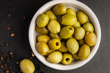 Green olives pickled seedless natural product tasty snack fresh delicious gourmet food background on the table rustic top view copy space