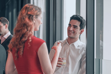 Business professionals networking and having casual conversation during corporate event.