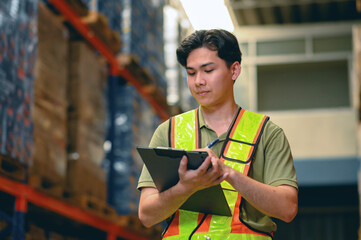 Asian man warehouse managers checking stock in workplace warehouse. industry logistic export import distribution concept.