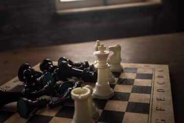 Chess board game concept of business ideas and competition and strategy ideas concep. Chess figures on a dark background with smoke and fog. Selective focus