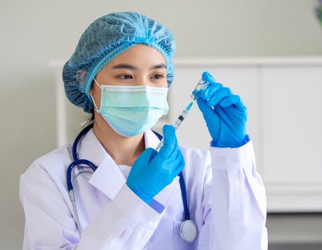 portrait of a female doctor holding a syringe,vaccines fight against virus covid-19 corona virus, doctor or scientist in laboratory holding a syringe with liquid vaccines for children or older adults,
