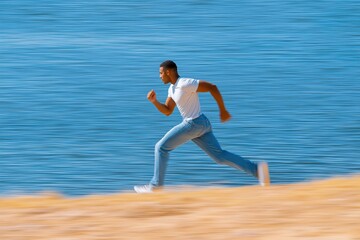 Obraz premium Dynamic Running Man Near Water's Edge