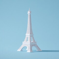 A white miniature replica of the Eiffel Tower standing on a solid pastel blue background