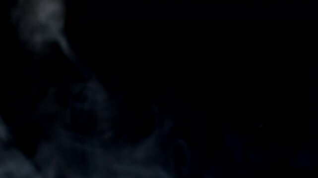 Vape smoke. Thick gray smoke is blowing from left to right. Thick smog. Cigarette smoke