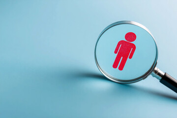 A magnifying glass focuses on a red figure of a person against a soft blue background