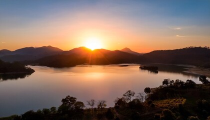Obraz premium Sunrise Over Suchitoto El Salvador With A Bright Orange Horizon Silhouetted Hills And Lake Suchitlan In The Foreground Reflecting The Morning Light