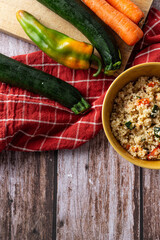 Top view of couscous salad in rustic bowl