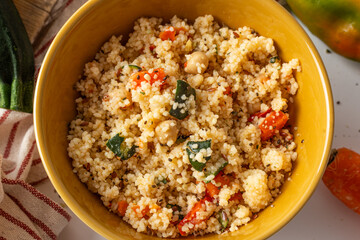 Top view of couscous salad in rustic bowl
