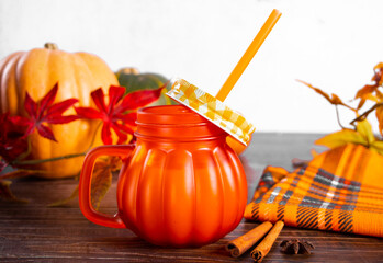 Pumpkin spice whipped latte in glass. Hot autumn drink beverage.