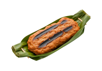 Grilled fish cake, attractively arranged on a bed of vibrant green banana leaves, showcasing a delicious and appetizing dish.