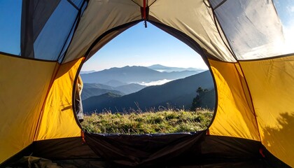 View from inside a yellow and gray tent pitched on grassy terrain overlooking misty mountain range at sunrise, symbolizing serenity, adventure, and connection with nature.