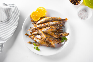 Fried capelin or smelt small fish with lemon