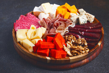 assortment of cheese meat cuts, on a plate, top view, no people,
