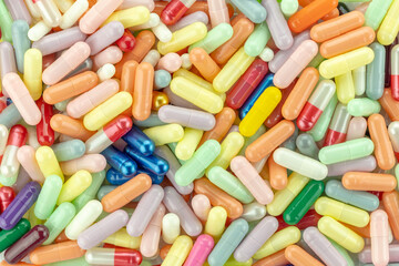 Pile of colorful capsules and pills isolated on white background with clipping path.