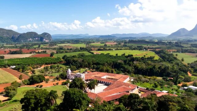Cuba's verdant Vinales Valley reveals a colonial building amid farmland and hills