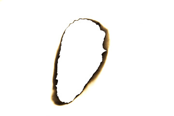 Burnt elongated hole in paper with charred edges isolated on white background with clipping path.
