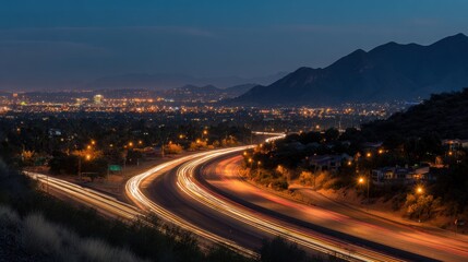 Fototapeta premium Long exposure of a city highway at night with mountain backdrop