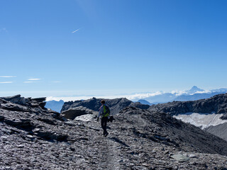 Hiker Walking on Rocky Trail Above the Clouds in the French Alps – Freedom and Adventure on Mont Cenis Ridge