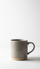 Fototapeta premium A grey mug sits on a white surface featuring a lightcolored bottom